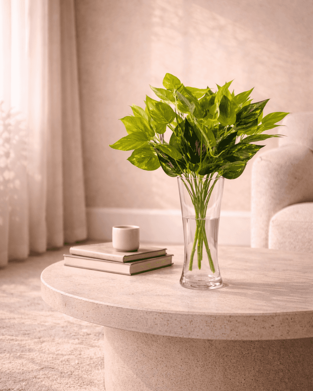 Artificial pothos plant bunch in vase on table for stylish home and office decor
